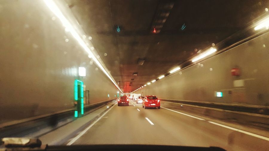 Cars in illuminated tunnel