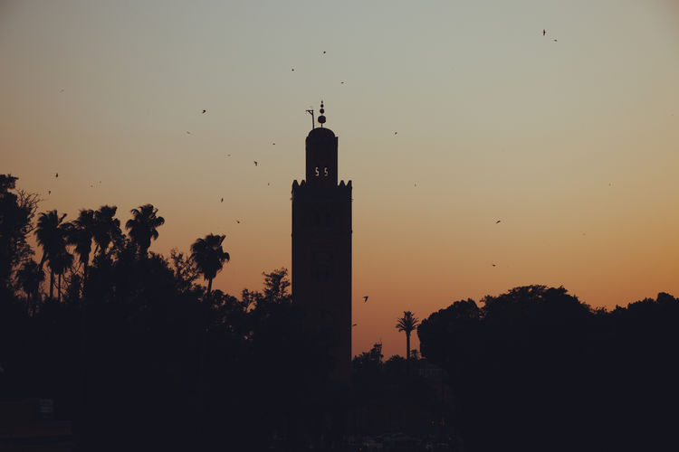 Silhouette of building against sky during sunset