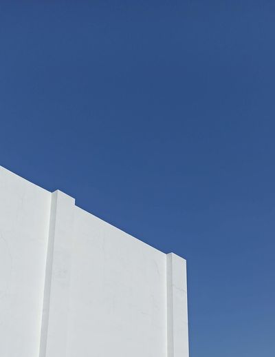 Low angle view of building against clear blue sky