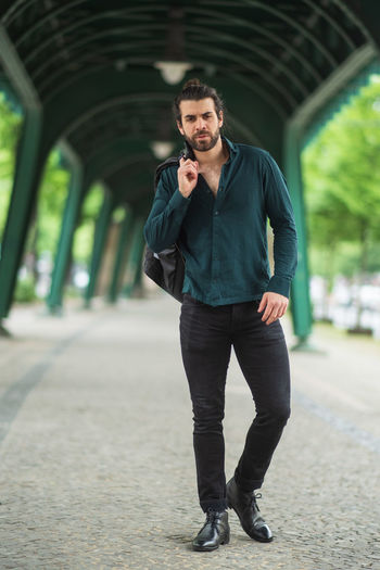 Full length portrait of young man standing outdoors