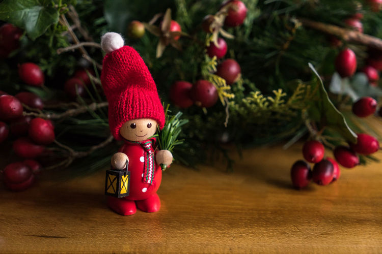 Close-up of figurine on table by christmas decoration