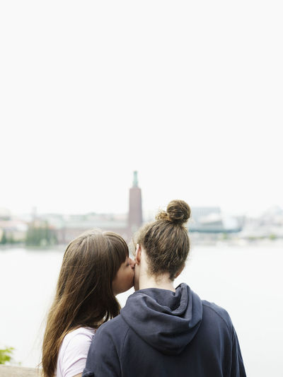 Woman kissing man outdoors