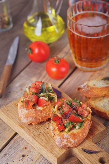 Italian bruschetta with chopped tomatoes, basil, herbs and olive oil on grilled crusty bread