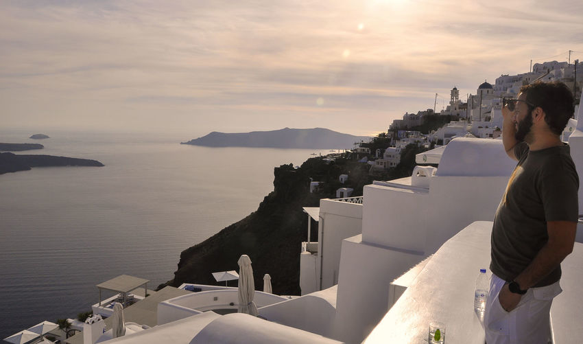 Side view of man standing on building at santorini
