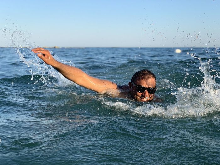 Man swimming in sea water 