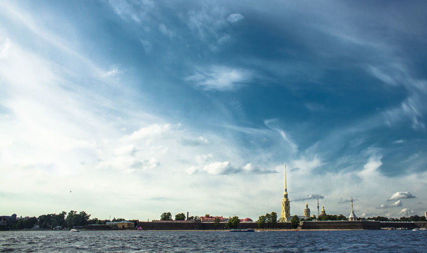 Saints peter and paul cathedral and river against sky in city
