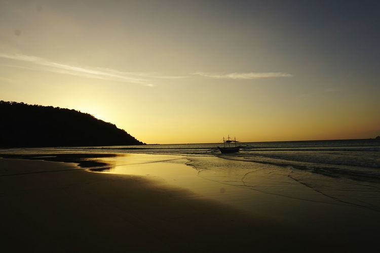 Scenic view of sea at sunset