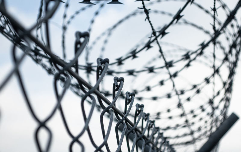 Low angle view of barbed wire fence
