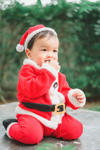 Portrait of cute baby girl wearing red hat