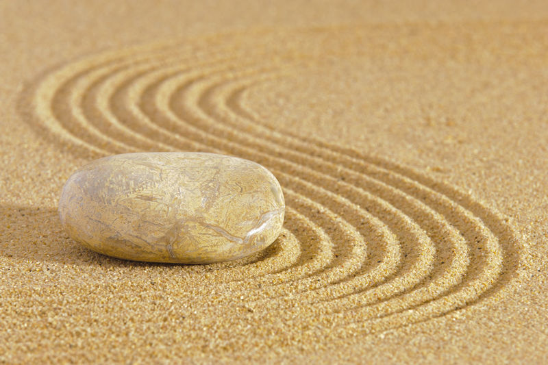 Japanese zen garden in sand with stone
