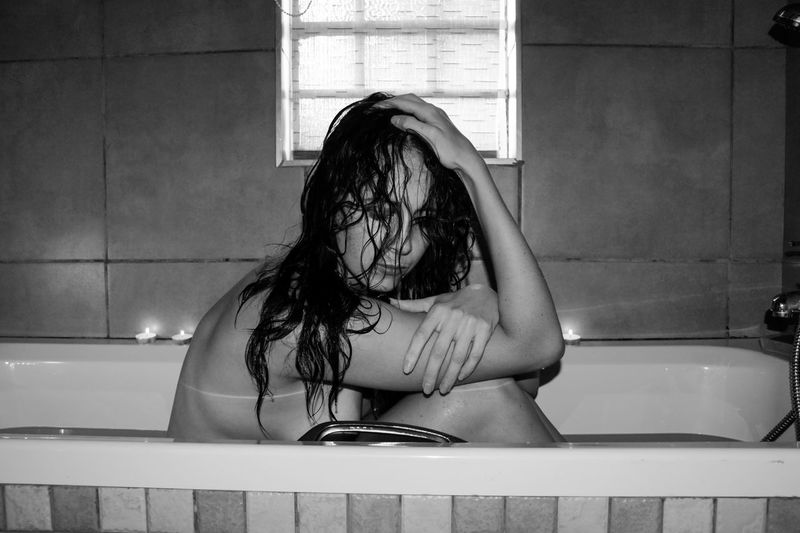 Woman sitting in bath