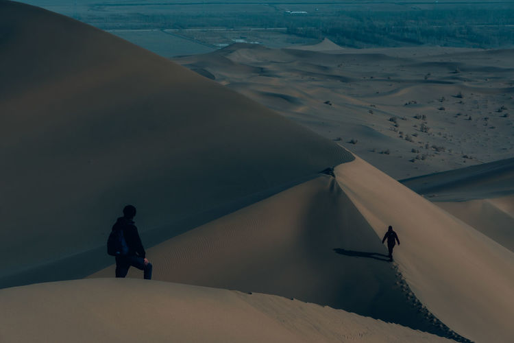 Two men standing on desert 
