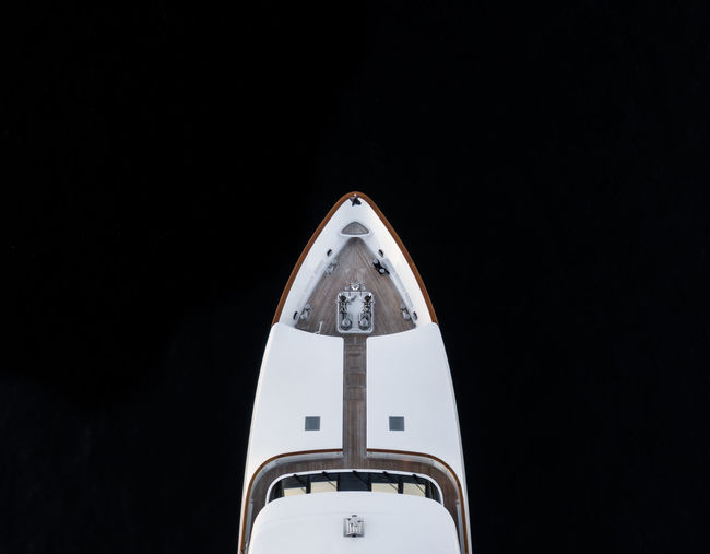 Aerial bird's eye partial view of the bow of a long white luxury yacht in sydney, australia