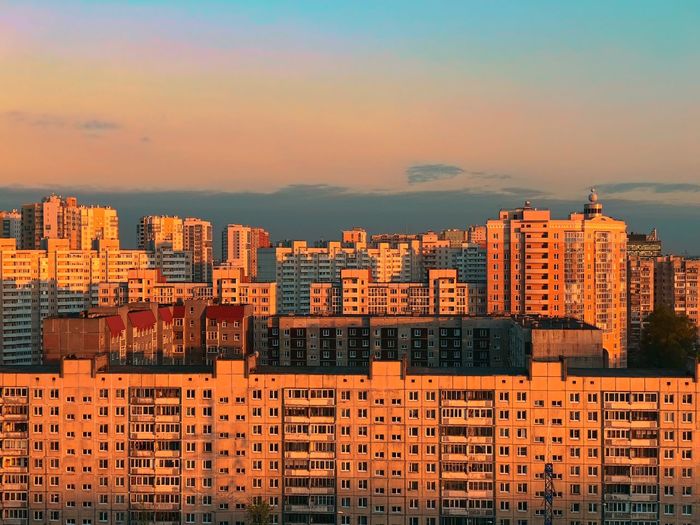 Buildings in city against sky during sunset
