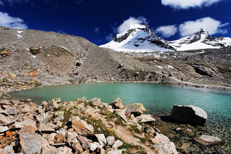 Scenic view of snowcapped mountains by river