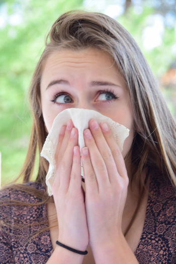 Allergy season young woman sneezing
