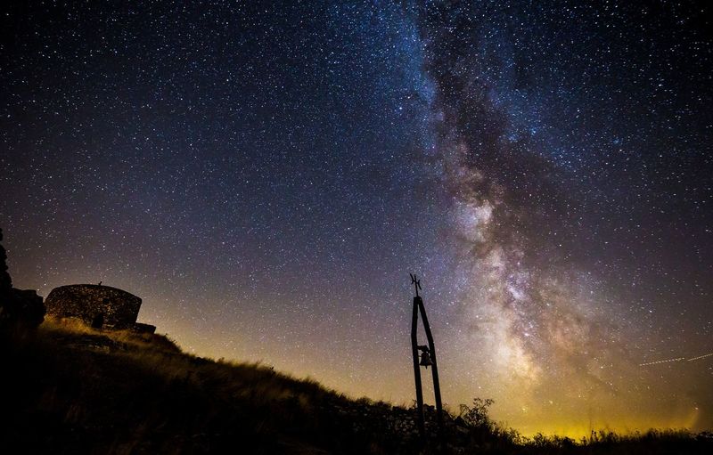 Milky-way with a bell silhouette in italy