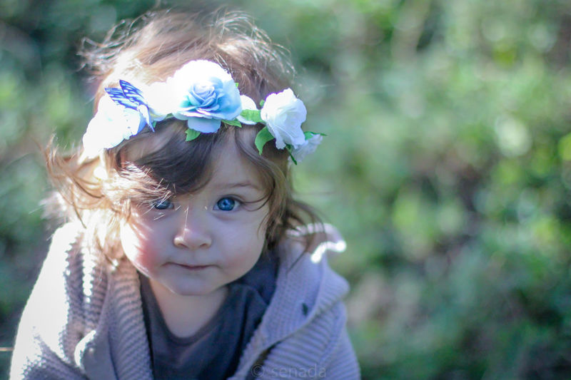 Close-up portrait of cute baby girl wearing flowers