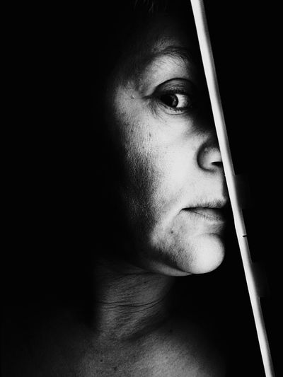 Close-up portrait of woman in darkroom