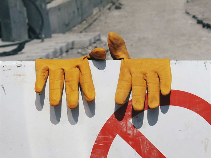 Close-up of gloves on signboard