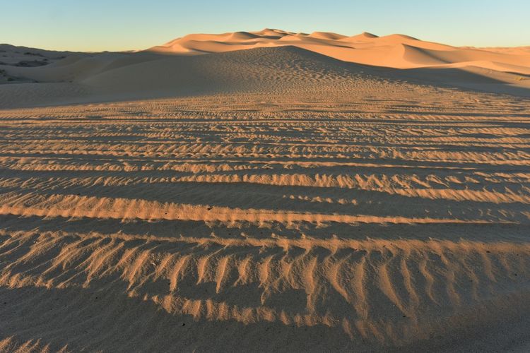 Scenic view of desert against sky during sunset