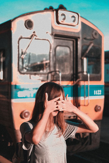 Portrait of woman holding train