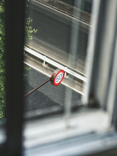 Speed limit sign 50 seen through window