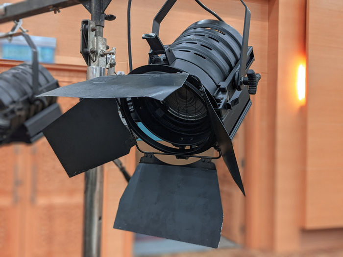 Close-up of camera hanging against metal wall