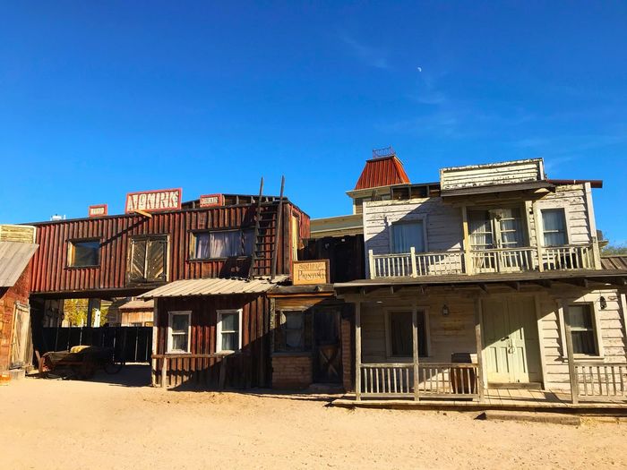 Low angle view of buildings against clear blue sky