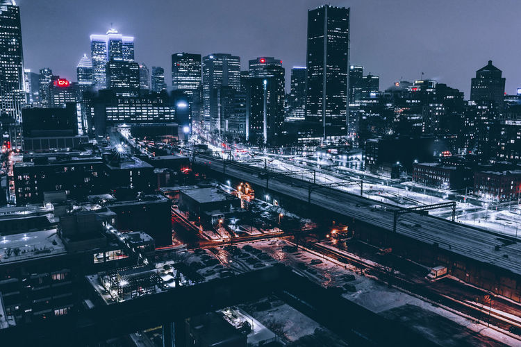 Illuminated cityscape against sky at night