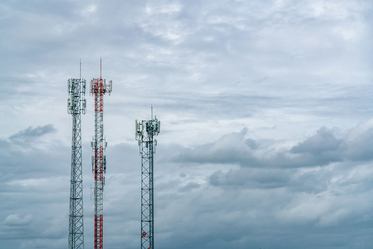 Telecommunication tower with white cloudy sky. antenna. radio and satellite pole. communication.
