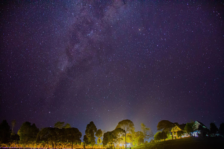 Low angle view of illuminated star field against sky