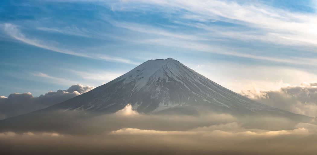 Scenic view of snowcapped mountains against sky during sunset