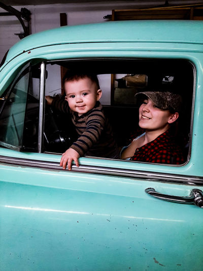 Portrait of a smiling mother and son in car