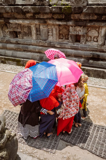 Rear view of women with umbrella