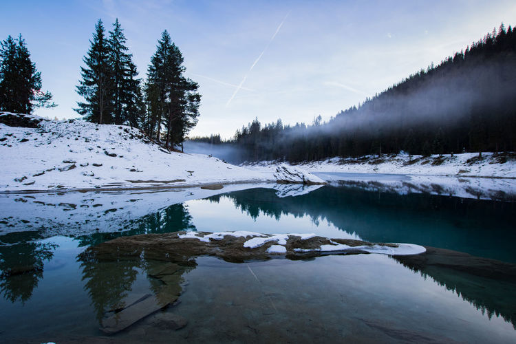 Scenic view of frozen lake against sky