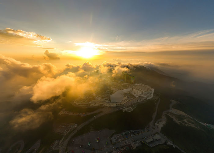 Aerial view of cityscape against sky during sunset