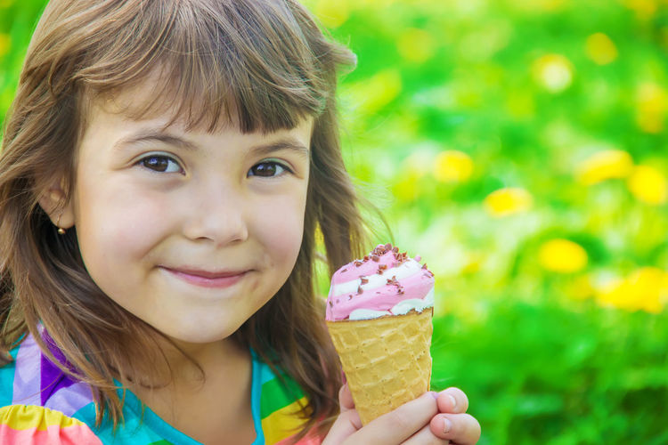Close-up of young woman holding ice cream cone