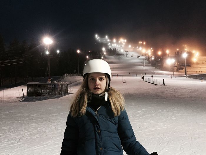 Portrait of woman at night on ski slope