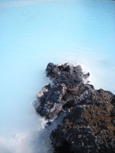Rock formations in sea against sky