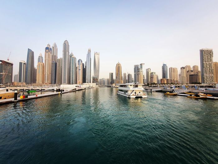 Panoramic view of river and buildings against clear sky