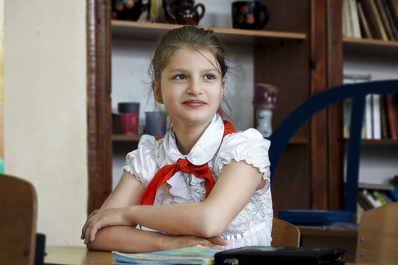 Portrait of smiling girl sitting at home