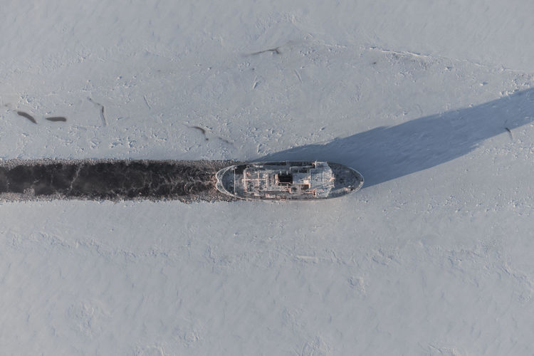Icebreaker in the ice fields. harsh northern conditions. laying of the navigable channel.