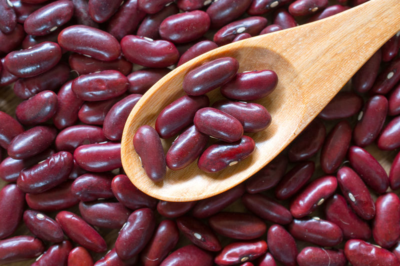 Close up of wooden spoon in kidney beans
