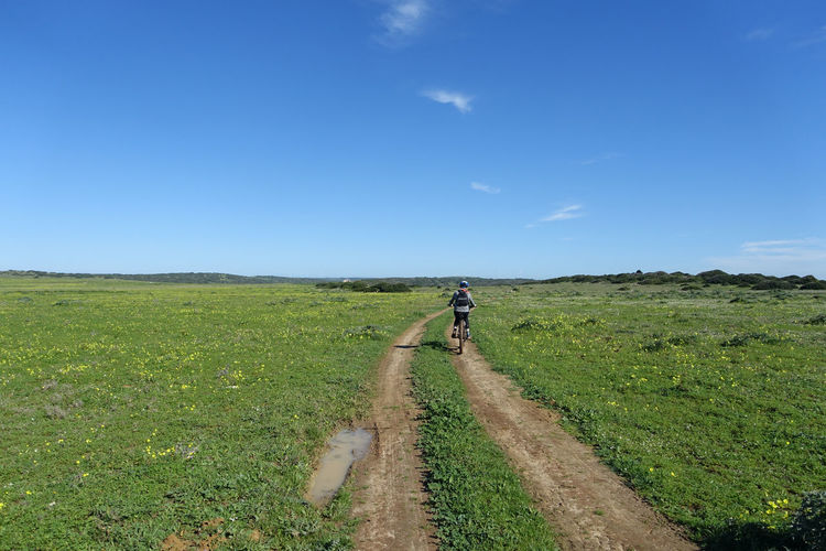 Teenager riding an electric mountain bike on a remote country track