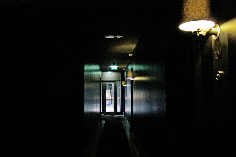 Illuminated underground walkway at night