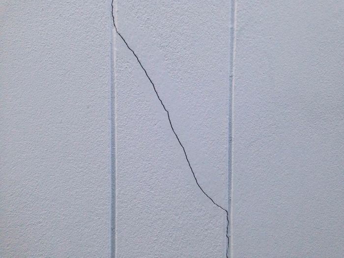 Close-up of cracked white wall