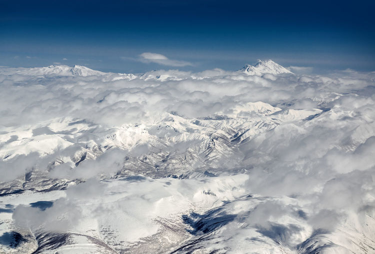 High angle view of clouds over snow covered landscape