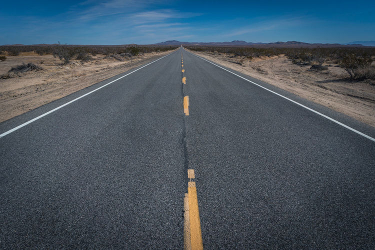 Road amidst landscape against sky