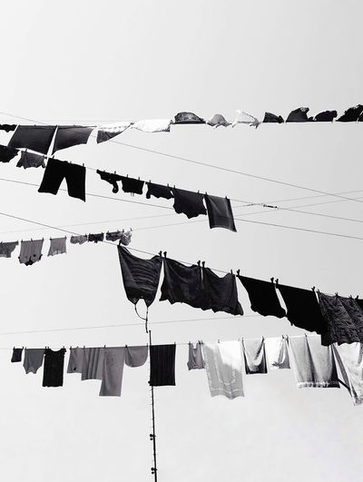 Low angle view of clothes drying against clear sky